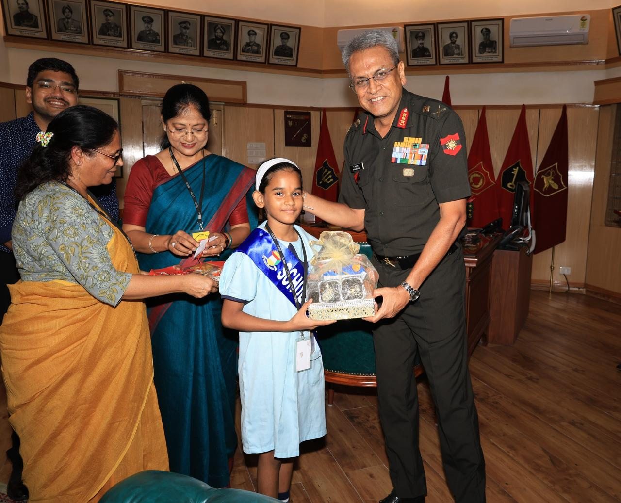 A Scholars' Home student presenting a handmade gift to Lieutenant General Anindya Sengupta
