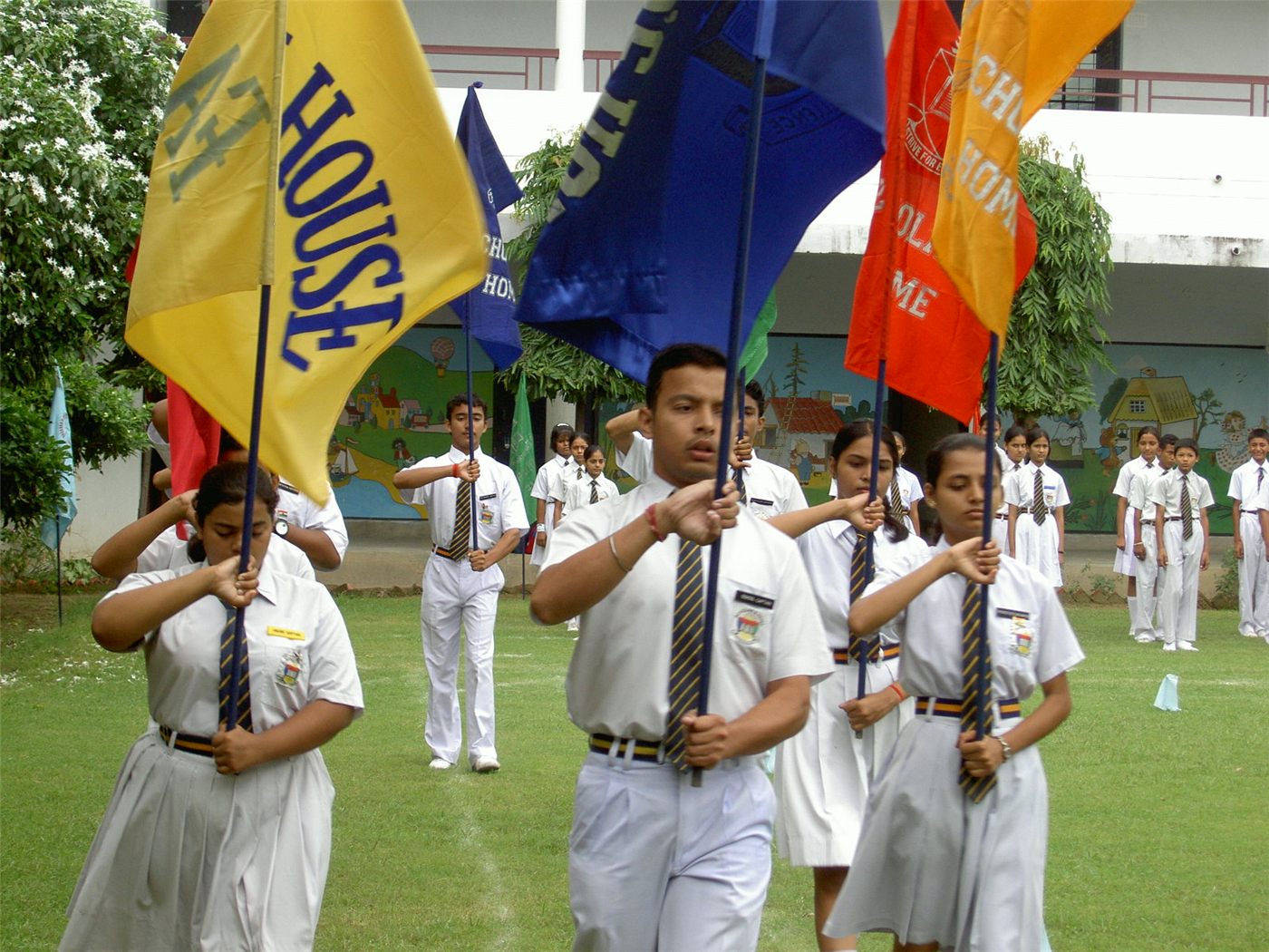 The four house flags of Scholars' Home — Faith, Hope, Joy and Peace — at a school ceremony